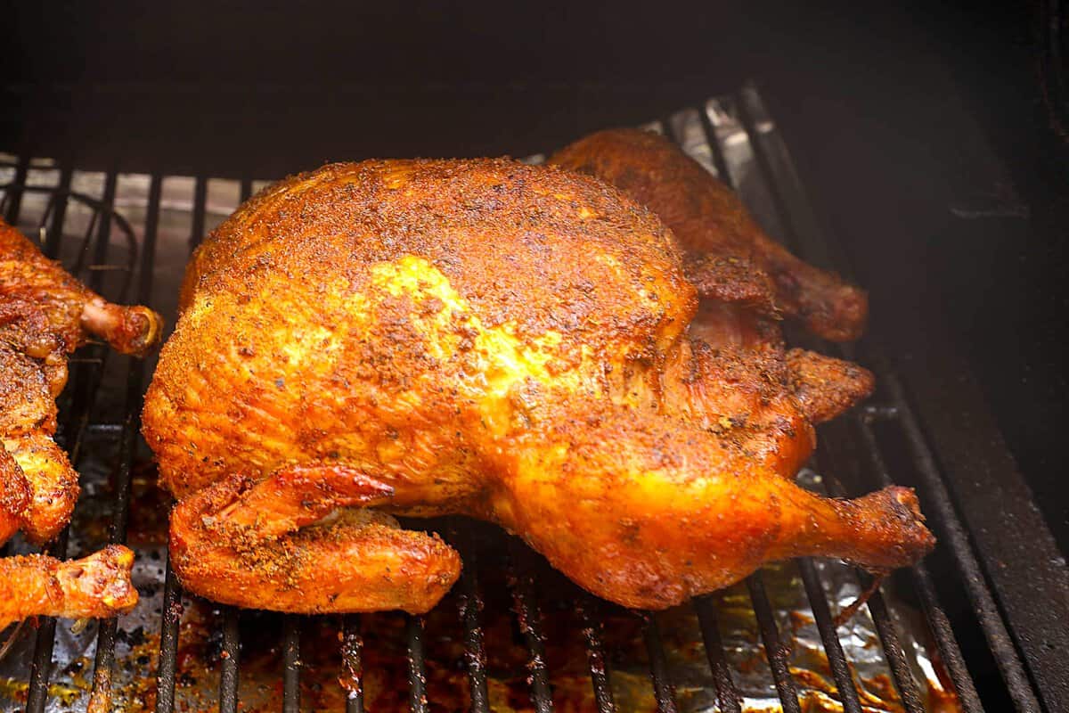 A smoked chicken ready to take out of the pellet grill and serve.