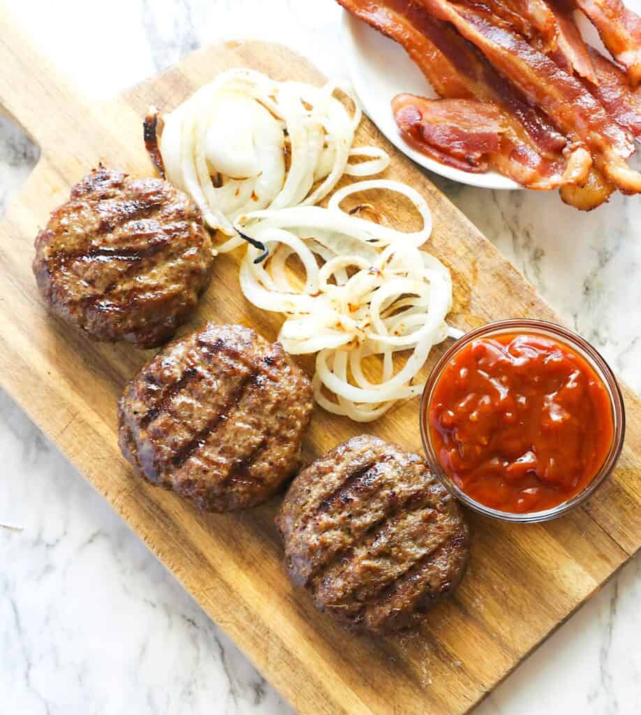 Homemade BBQ bacon burgers ready to assemble.