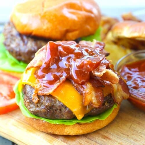 Topping a grilled burger with BBQ sauce and bacon for the best backyard burger you'll enjoy.