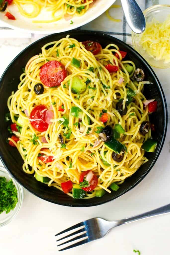 Getting ready to serve up a fresh, vibrant California spaghetti salad for an easy potluck recipe.