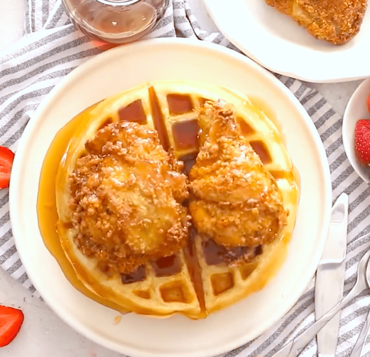 Drizzling pancake syrup on a couple of waffles topped with fried chicken for classic soul food.