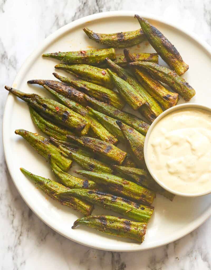 Serving up grilled okra with dipping sauce for a traditional Southern side.