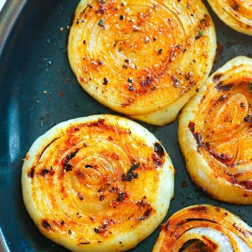 Pulling onions off the grill for a smoky side perfect for picnics.