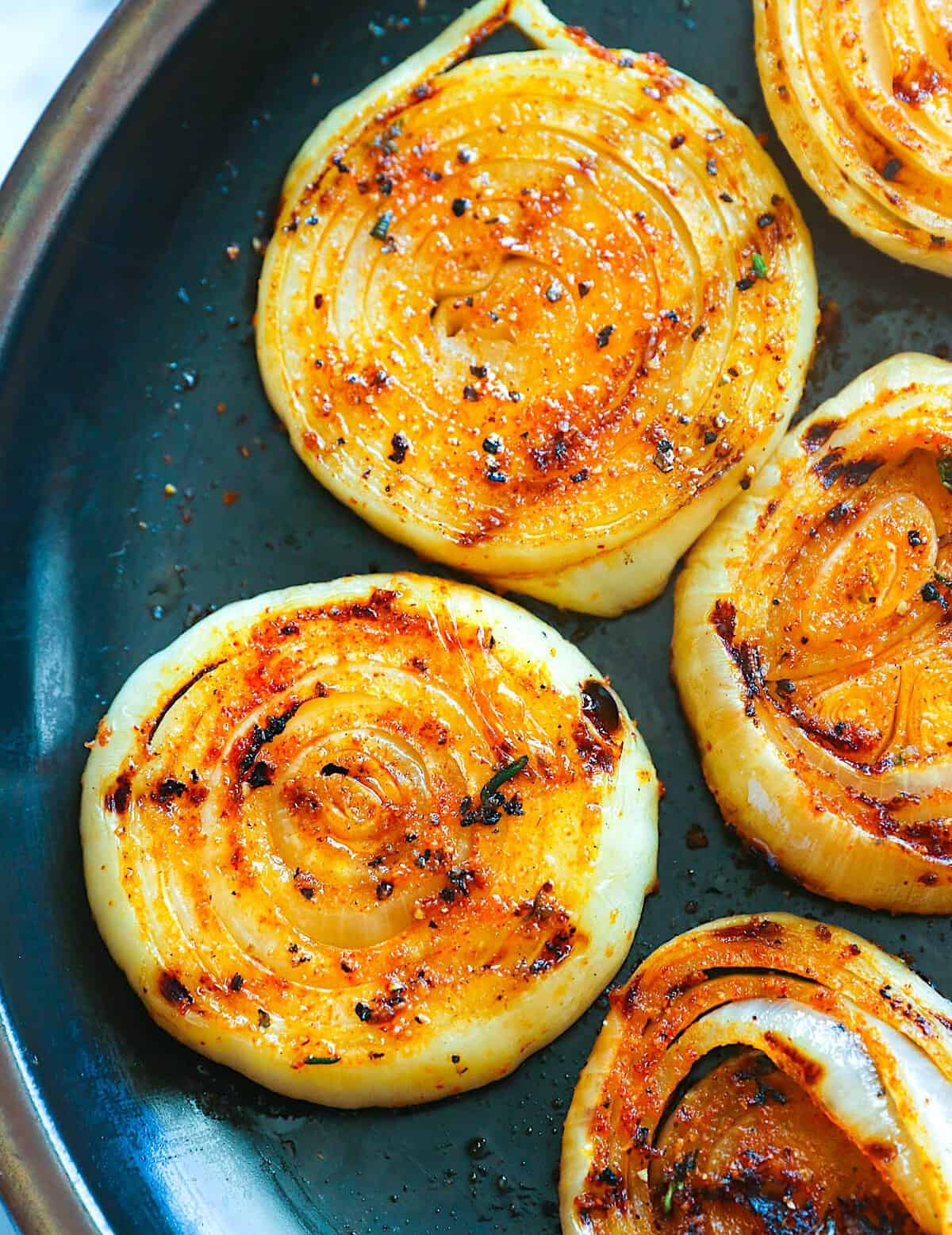 Pulling onions off the grill for a smoky side perfect for picnics.