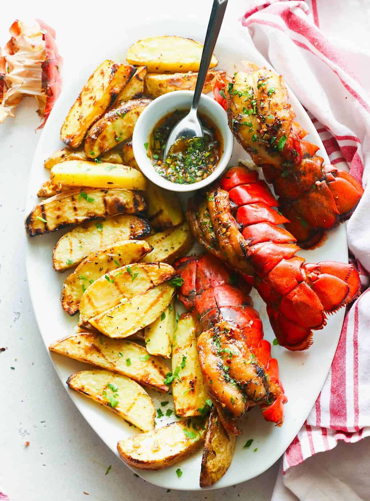 Serving grilled potato wedges with smoked lobster for an elegant dinner.