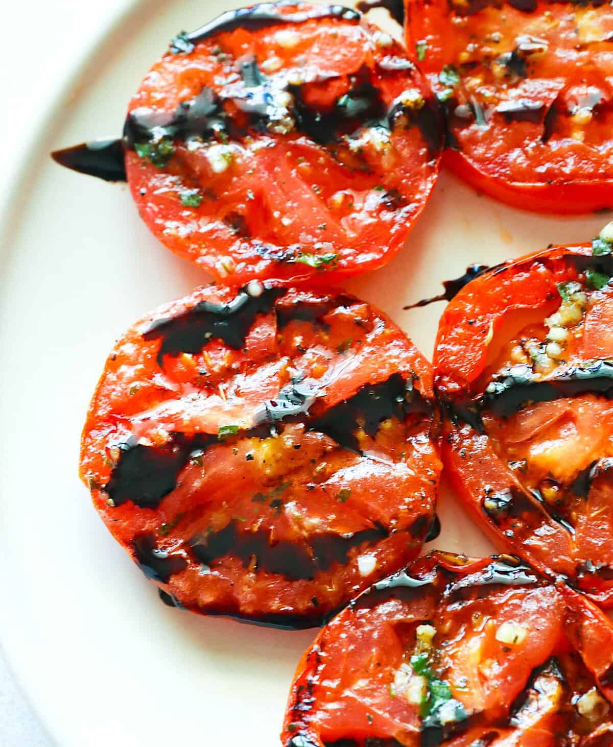 Tomatoes, marinated and grilled, then drizzled with a balsamic glaze.