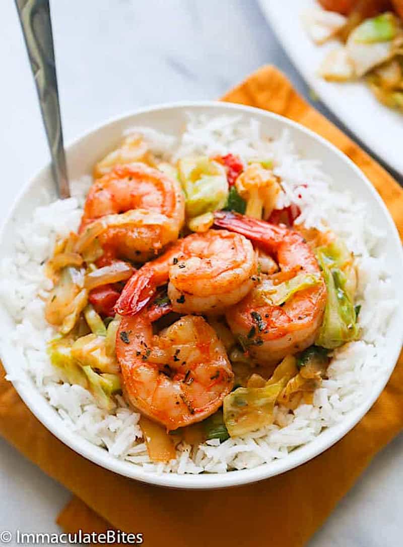 Enjoying Jamaican cabbage with shrimp over rice.
