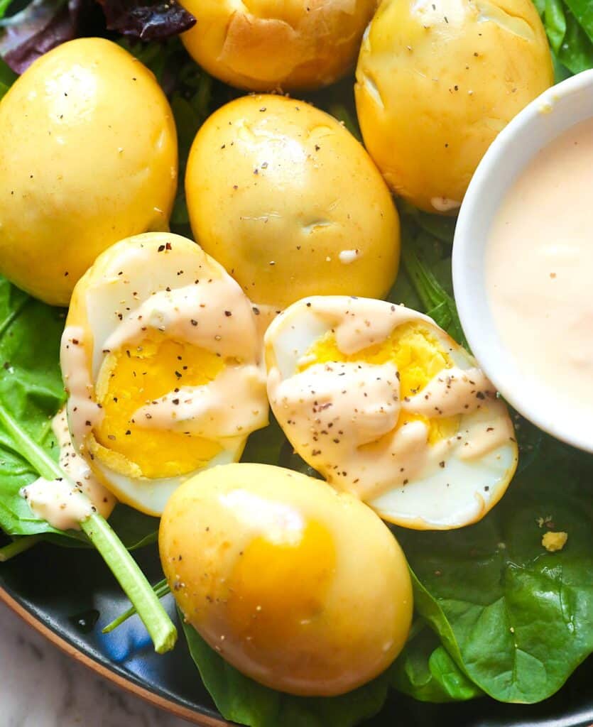 Drizzling smoked eggs with remoulade for a great snack or appetizer.