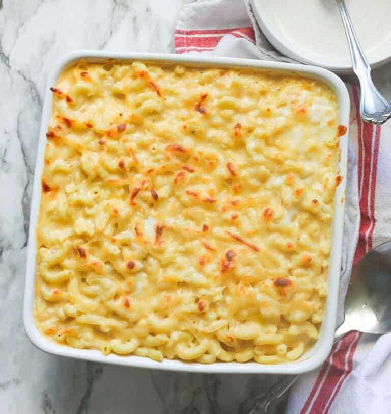 Showing off freshly baked smoked Gouda mac and cheese for to-die-for comfort food.