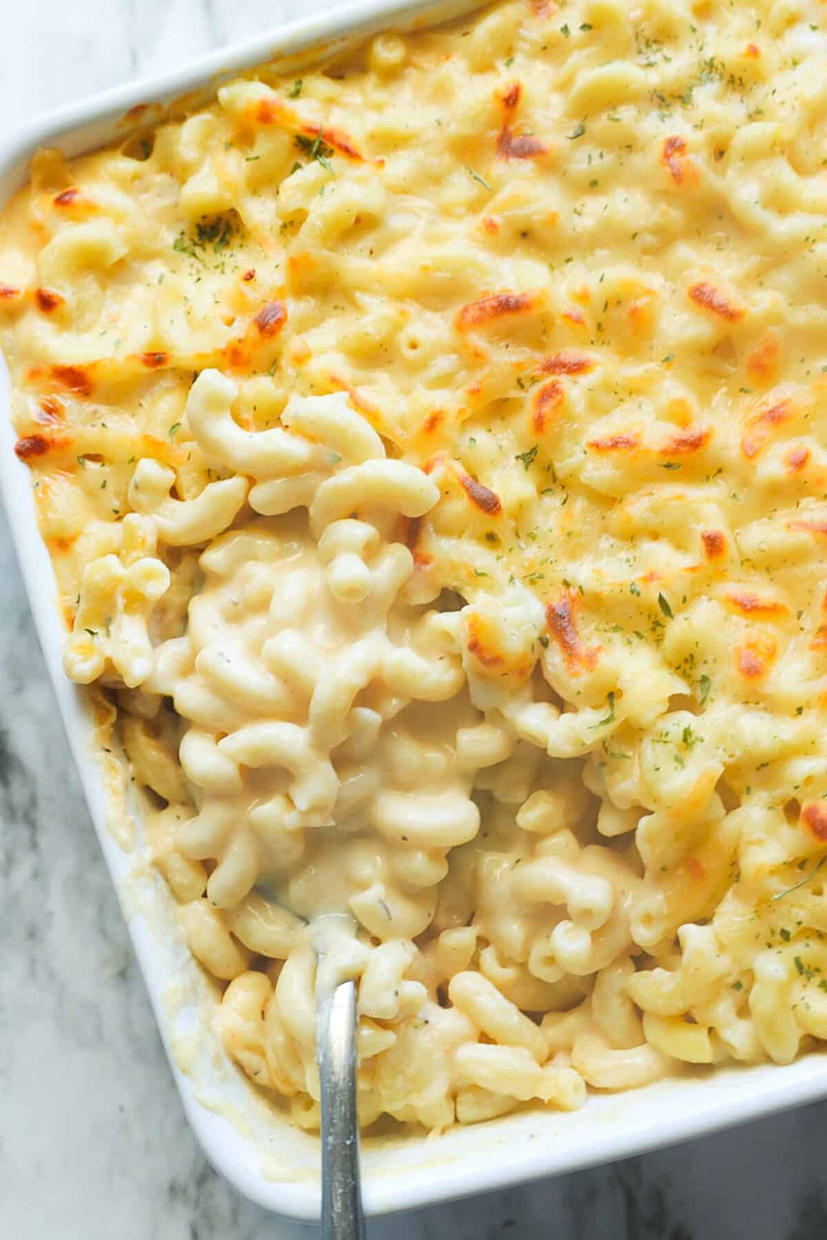 Spooning into a melty, creamy mac and cheese made even better with smoked Gouda.