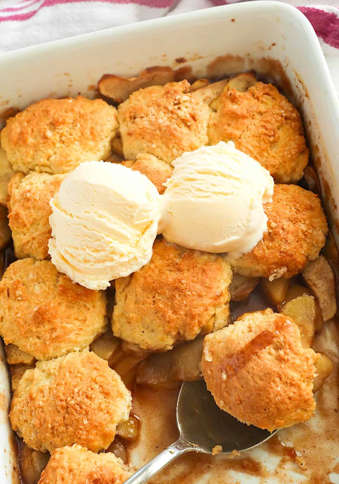 Warm apple cobbler with vanilla ice cream delivers a cozy fall dessert.