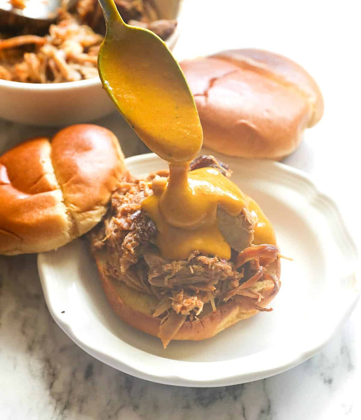 Giving a pulled pork sandwich a glow-up with mustard BBQ sauce.