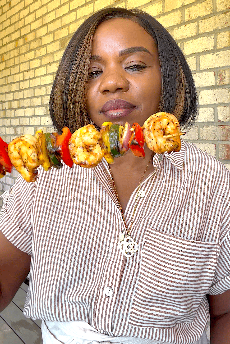 Imma holding up freshly grilled shrimp ready to enjoy.