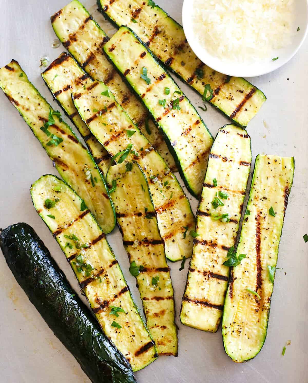 Grilled zucchini slices with a dipping sauce.