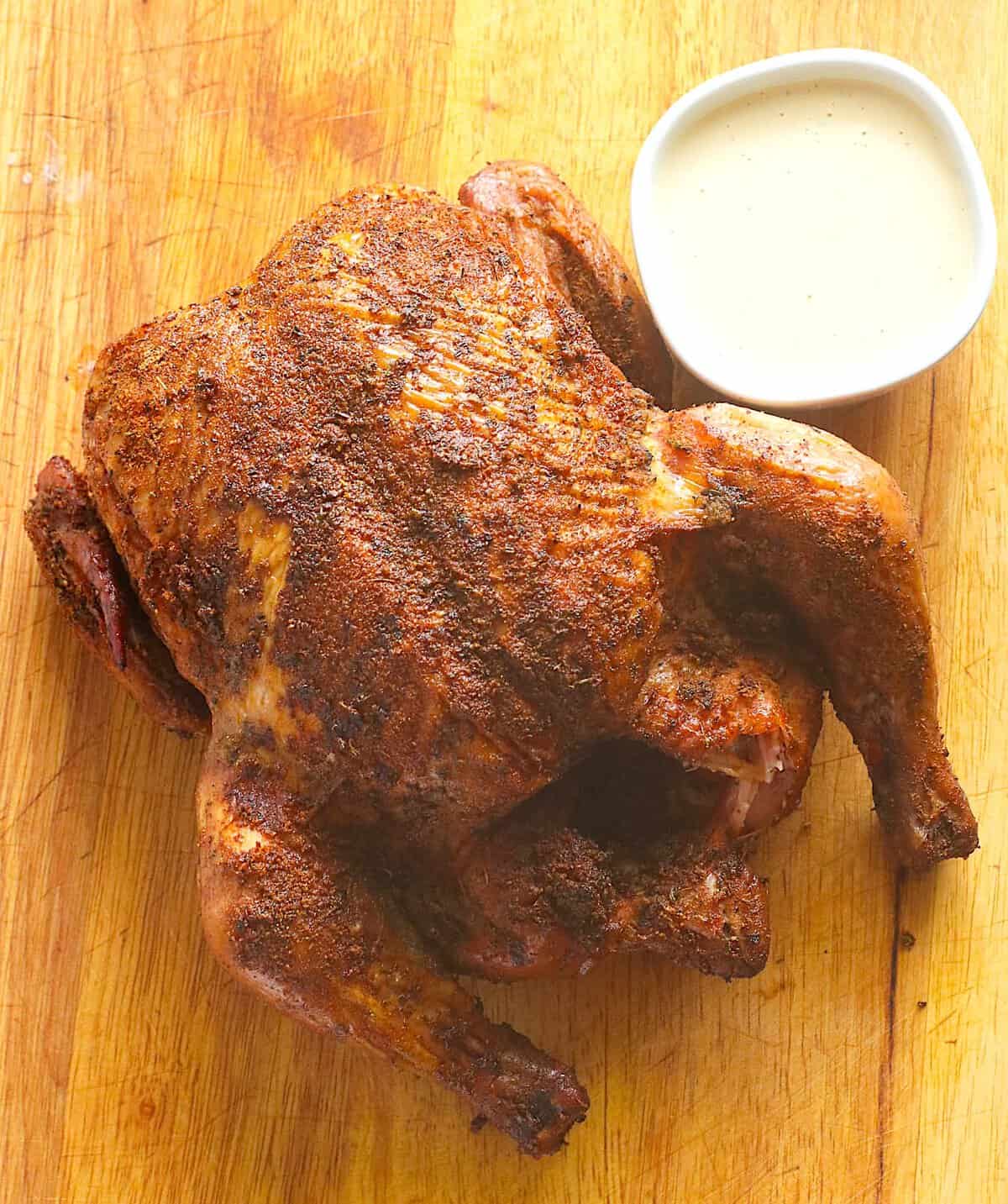 A freshly smoked chicken resting for about 10 minutes before cutting.