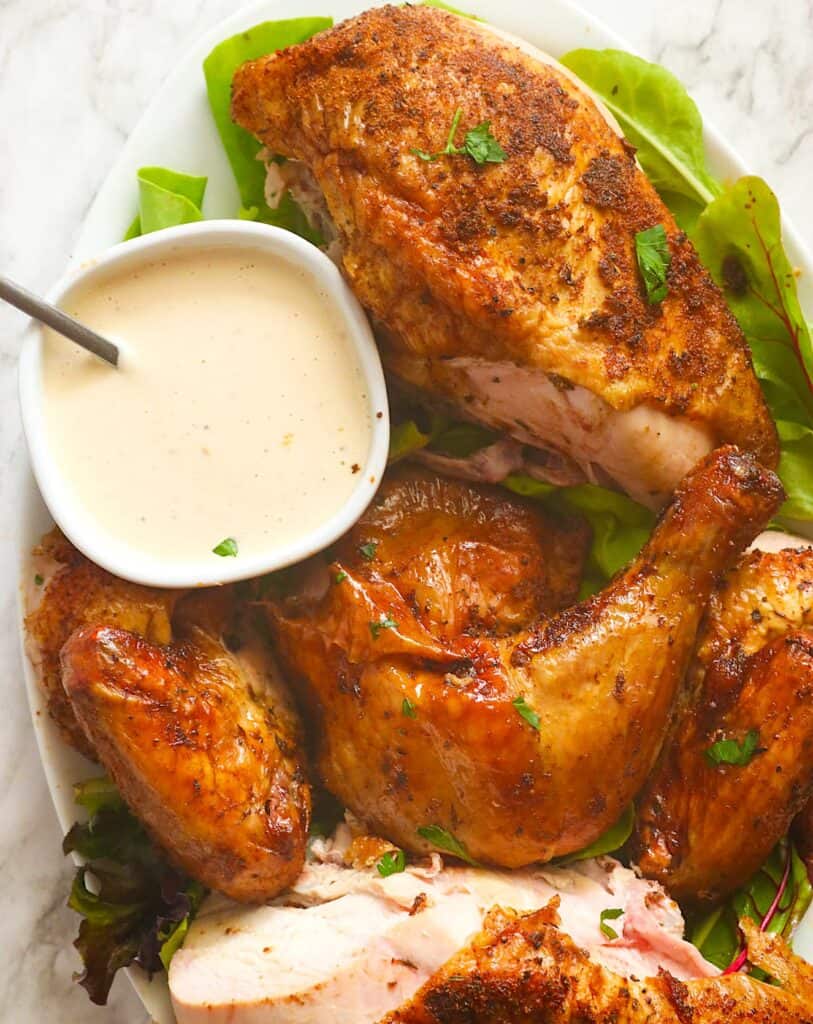 Serving up pellet grill whole chicken with remoulade sauce for the perfect cookout entree.