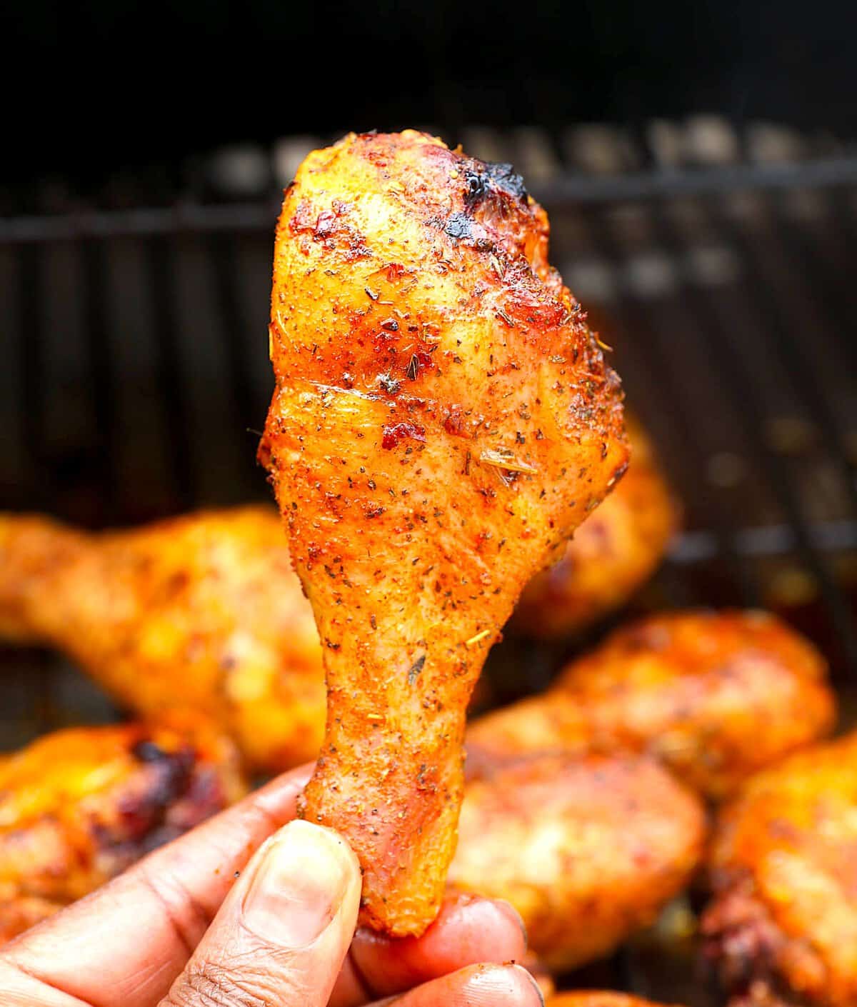 Pulling a chicken leg out of the smoker for inspection.