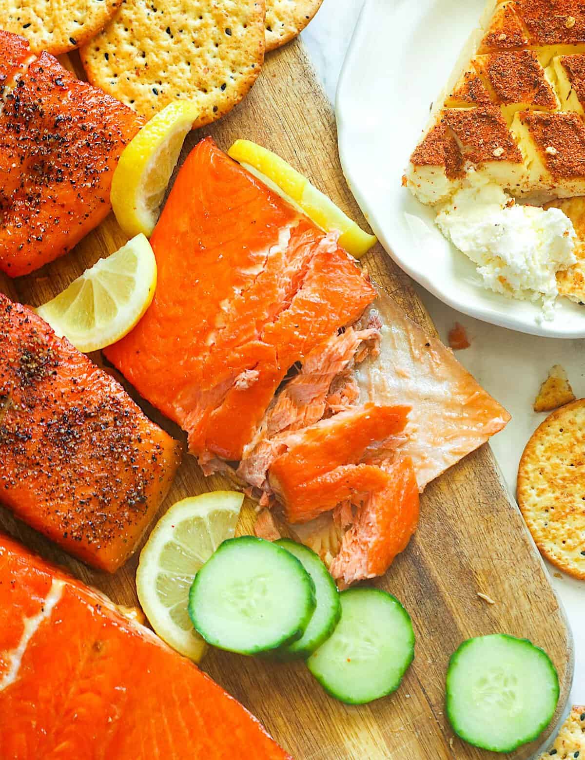 Enjoying smoked salmon with smoked cream cheese and veggies for a deliciously easy charcuterie board.