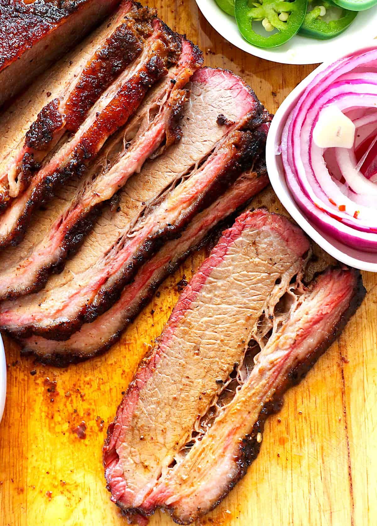 Slicing into perfectly smoked beef brisket after it has properly rested.