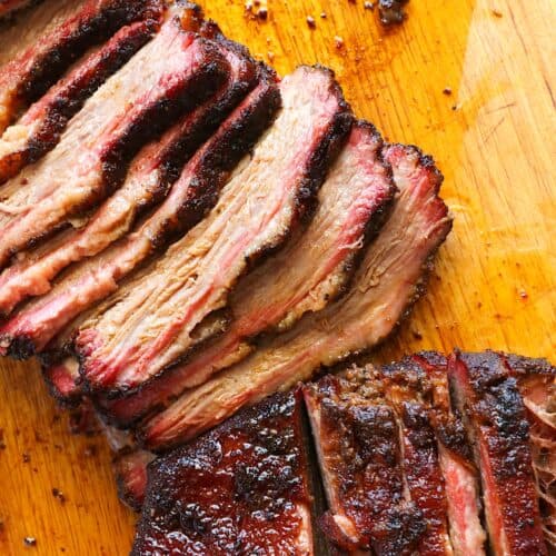 Slicing into juicy, fork-tender smoked beef brisket.