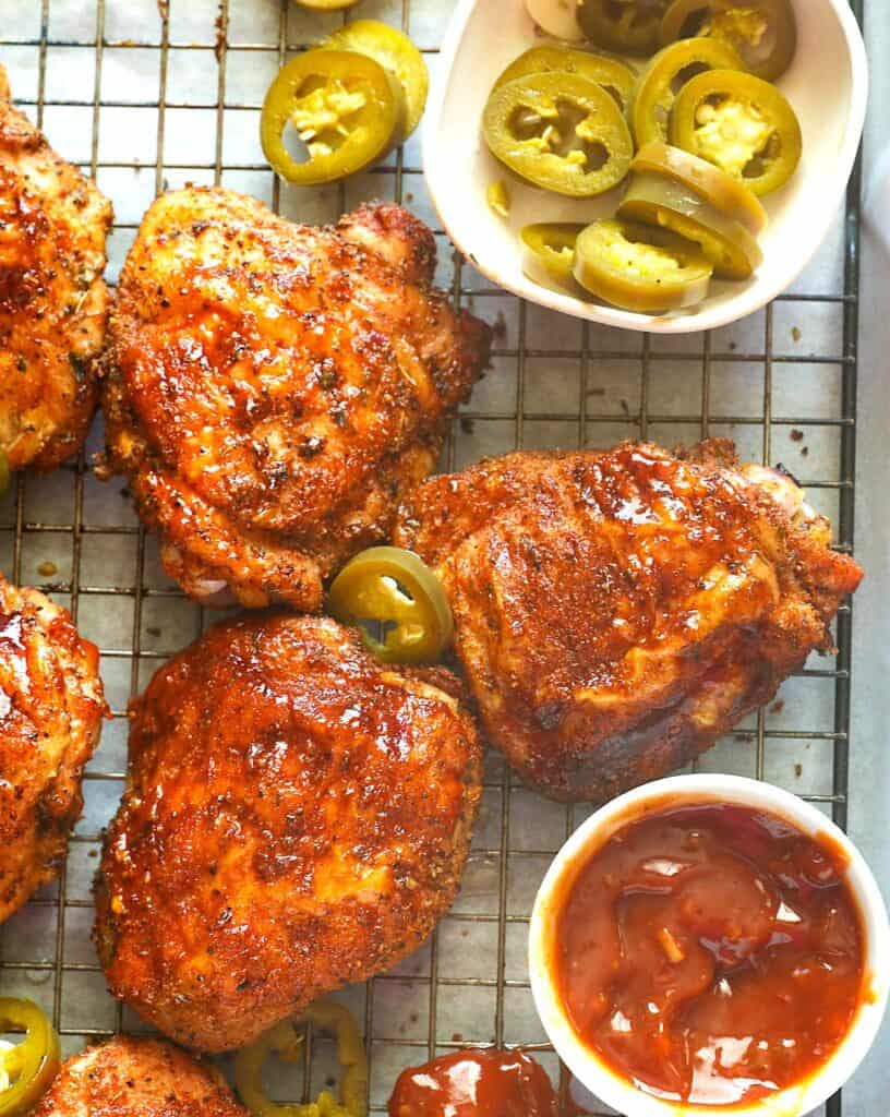 Amazing, smoky pellet grilled chicken thighs slathered with homemade BBQ sauce ready to serve up to a happy family.