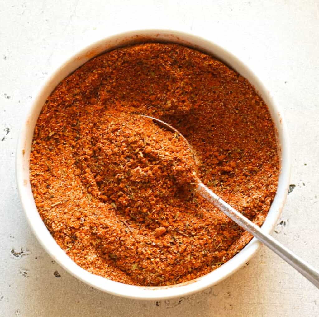 Spicy pulled pork rub ready to ramp up the flavor on a pork shoulder roast.