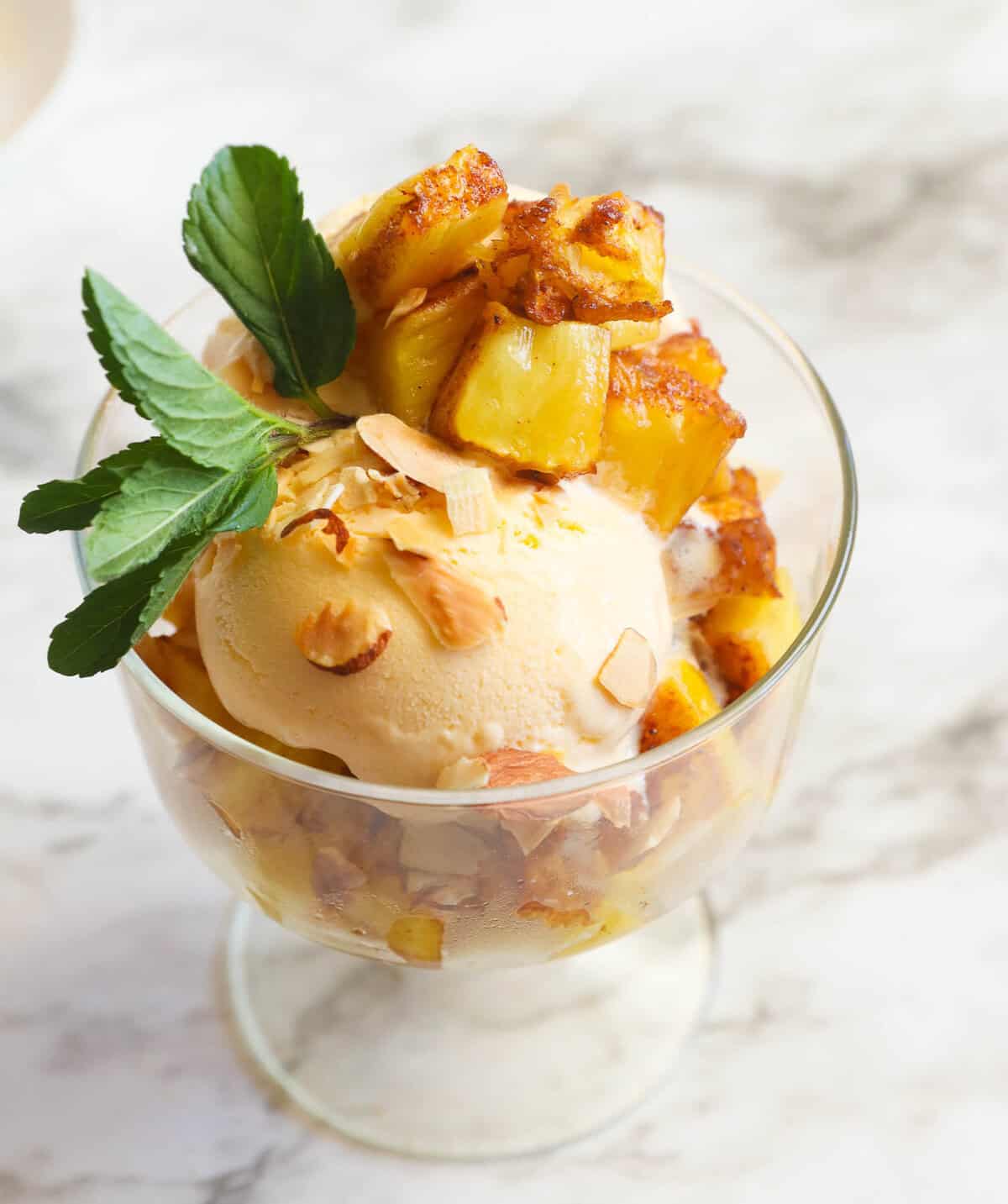 Enjoying warm smoked pineapple diced up over refreshingly cold ice cream.