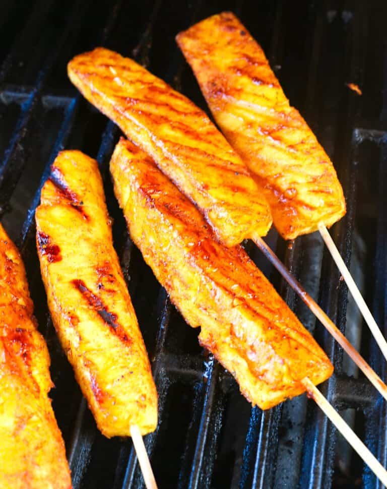 Pineapple wedges in the smoker for a tender, juicy appetizer, dessert or side dish.