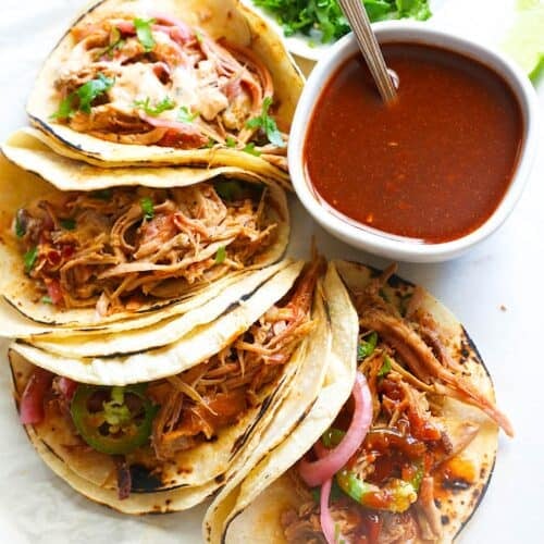 Getting ready to dive into spicy, comforting smoked pulled pork tacos with hot sauce.