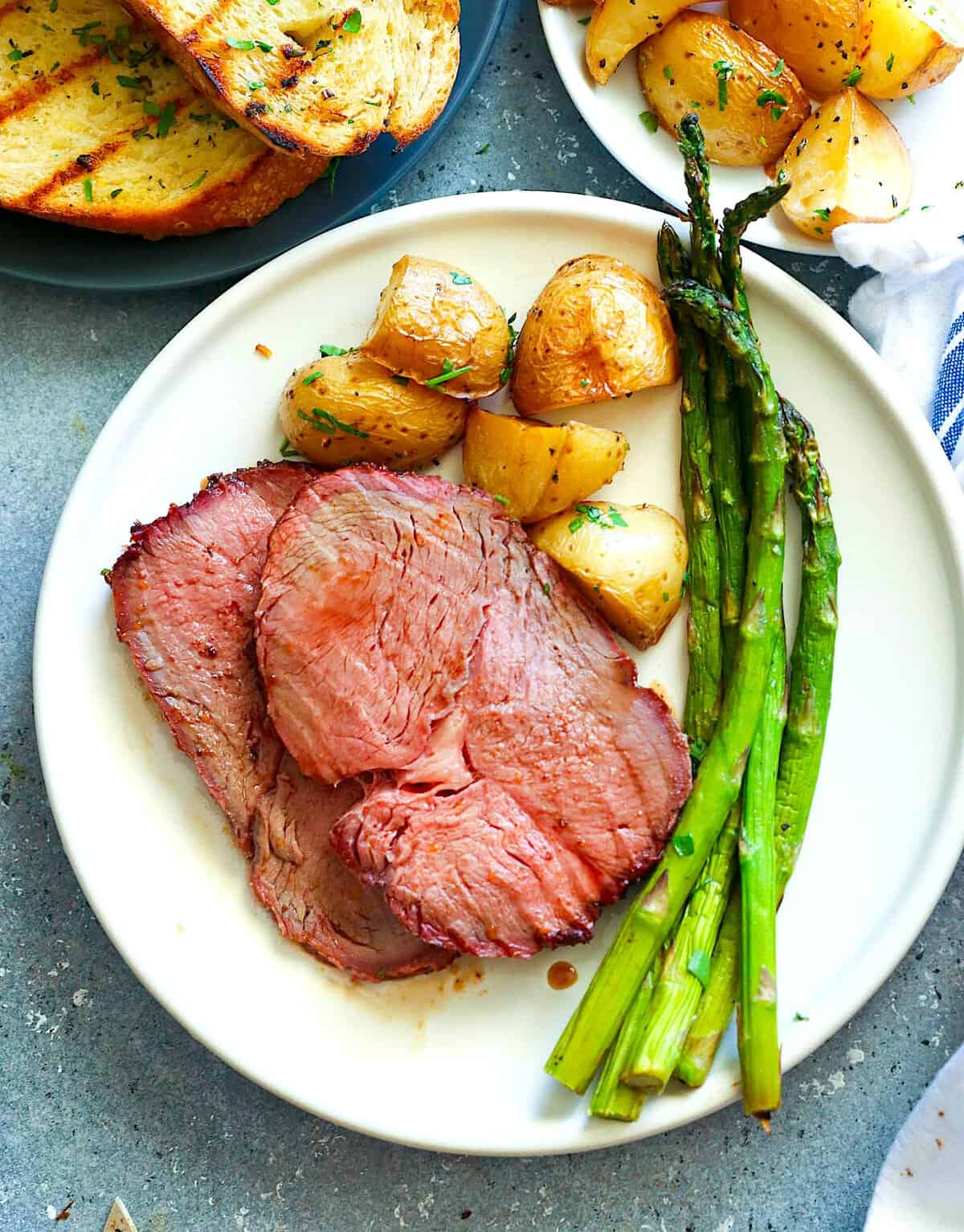 Serving up sirloin roast with smoked asparagus and roasted potatoes.