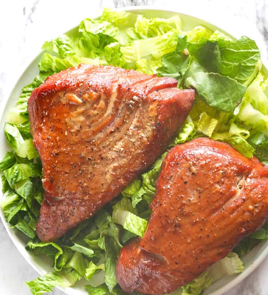 Freshly smoked tuna steaks on a bed of romaine lettuce.