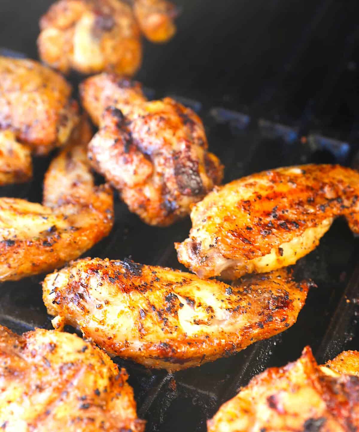 Taking smoked wings out of the pellet grill for an amazing appetizer for Game Day.