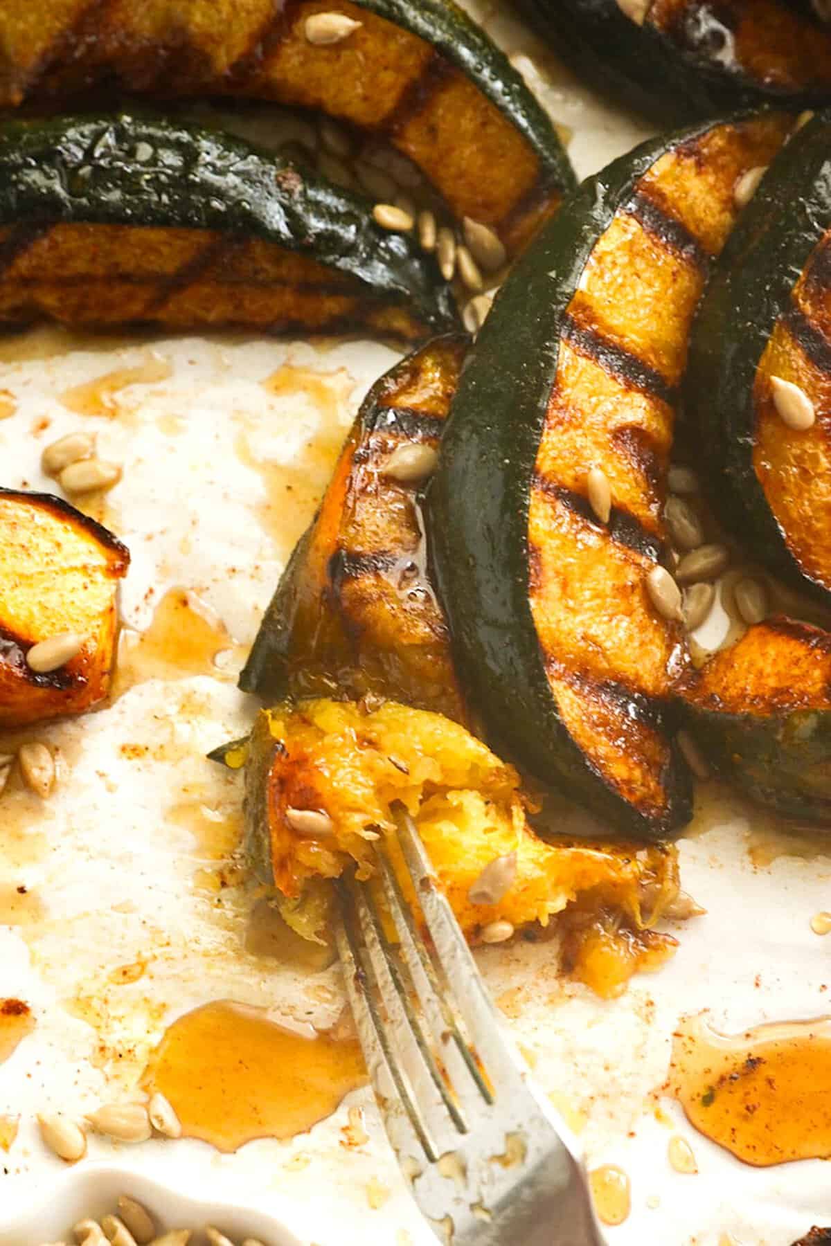 Forking into a tender wedge of acorn squash fresh from the grill.
