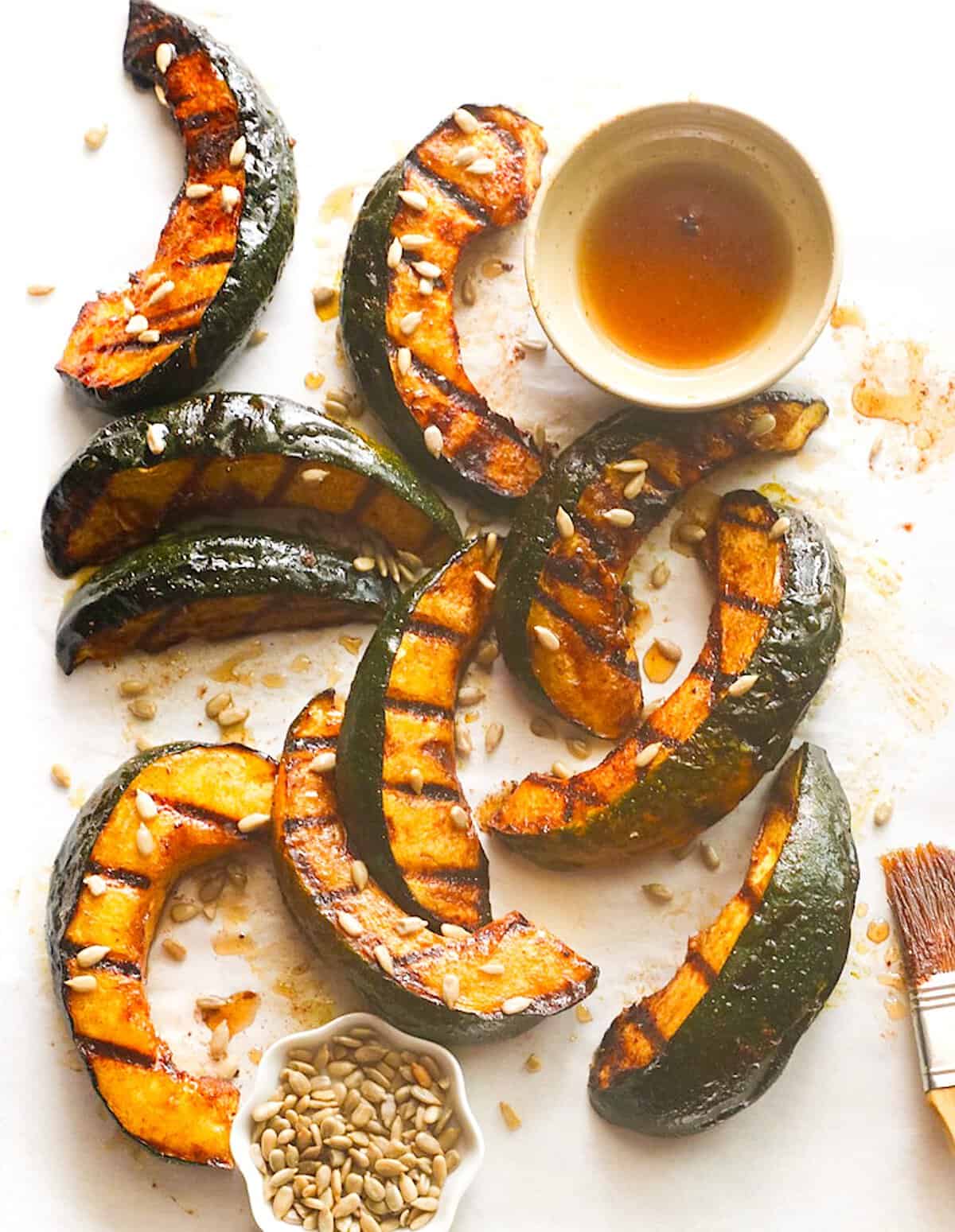Serving up freshly grilled acorn squash with maple syrup and toasted sunflower seeds.