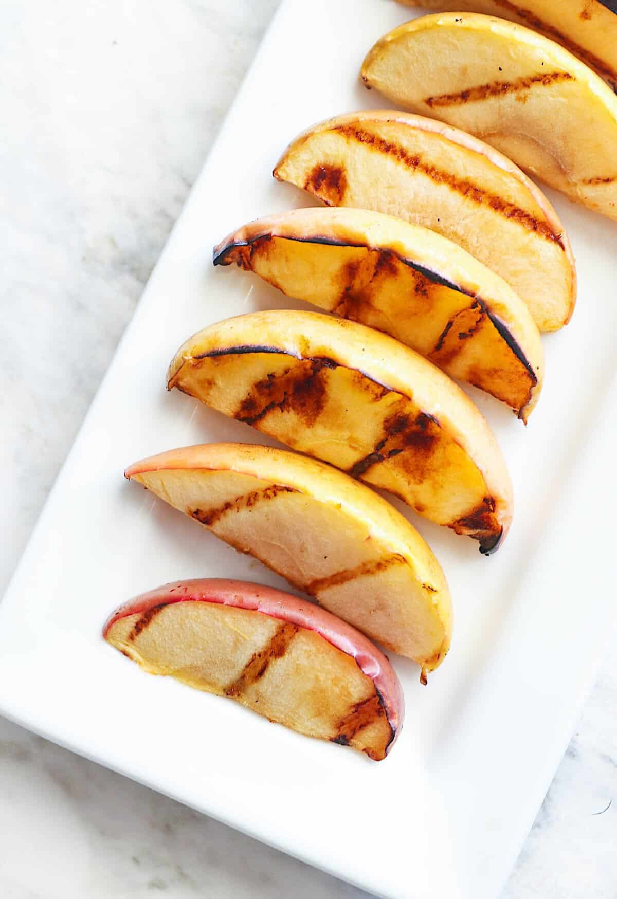 A platter loaded with apple wedges fresh from the grill.