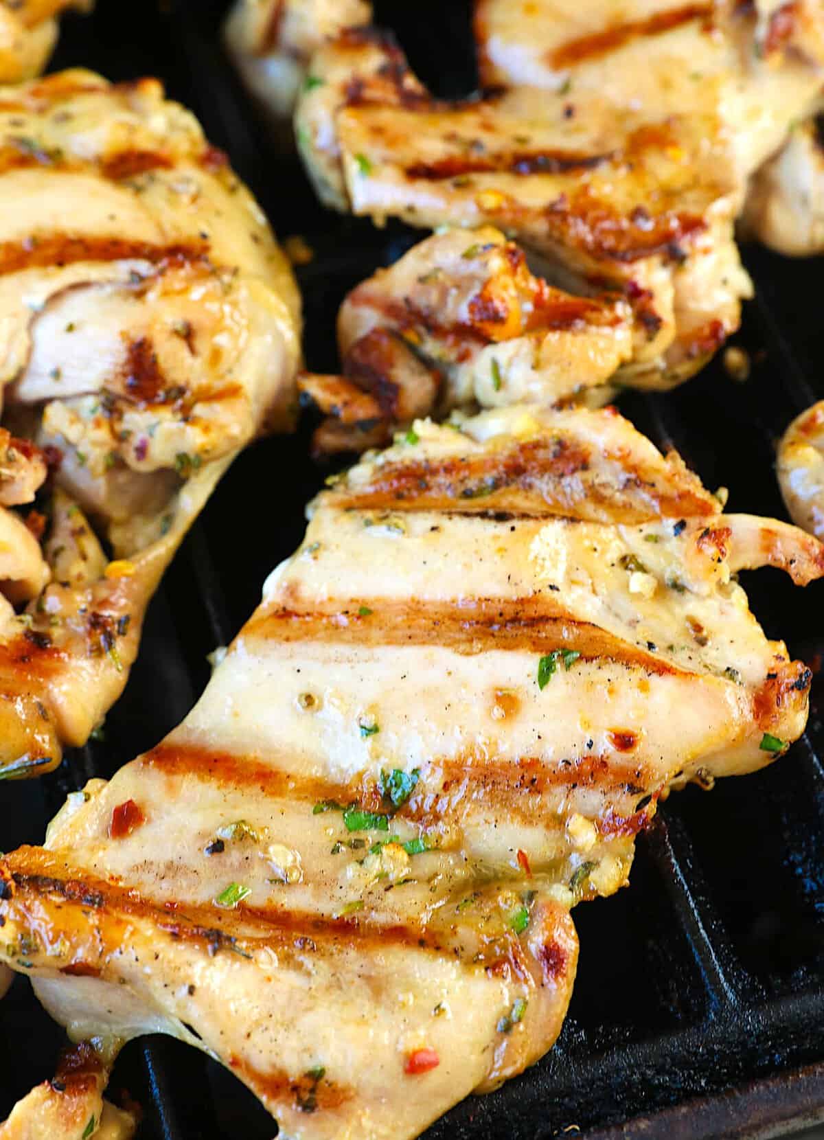 The grill loaded with boneless chicken thighs ready to serve up.