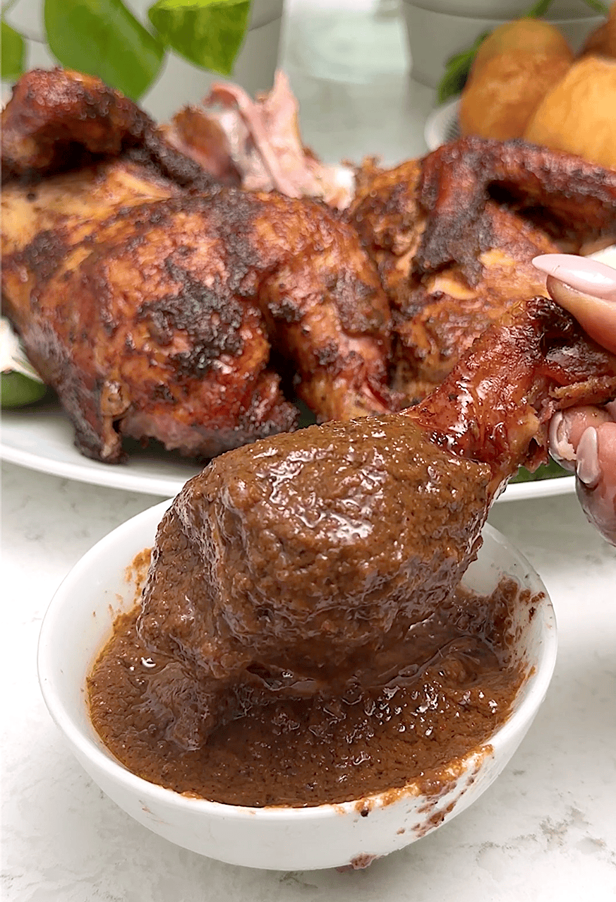 Dipping spicy chicken into the jerk sauce for a soul-satisfying entree.