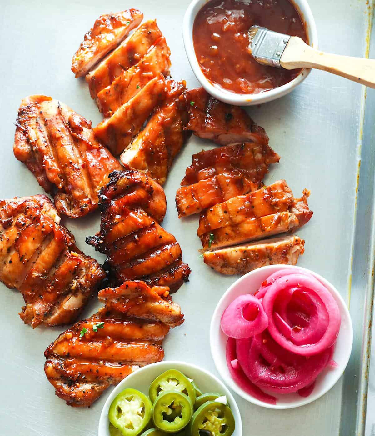 Serving up smoked chicken thighs with pickled onions, jalapeños, and homemade BBQ sauce.