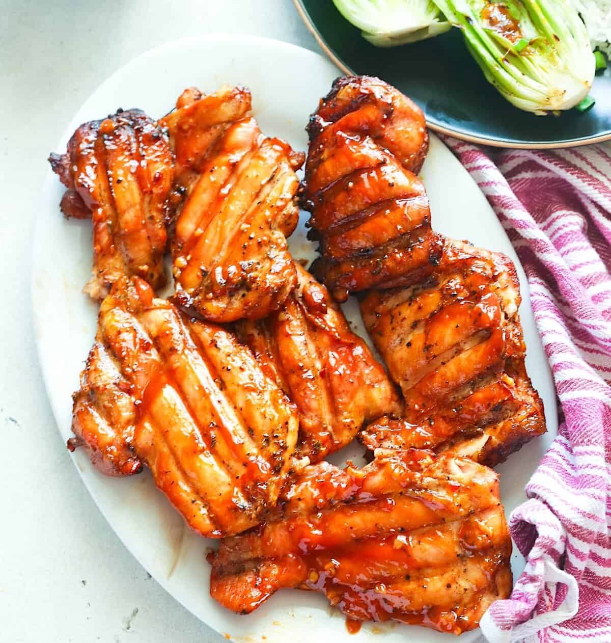 Serving up freshly smoked boneless chicken thighs with grilled bok choy.