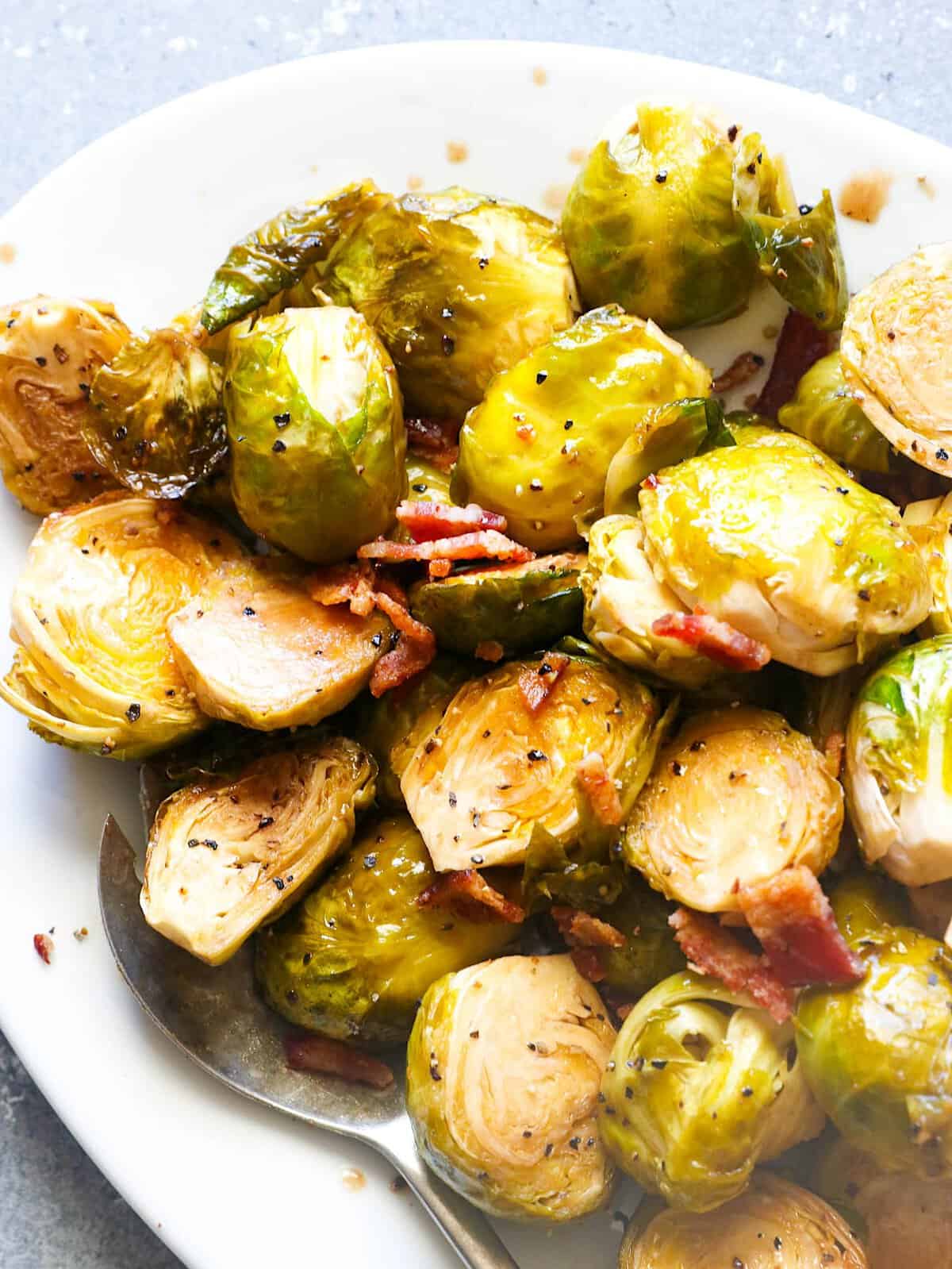 Tasty Brussels sprouts fresh from the smoker and topped with bacon.