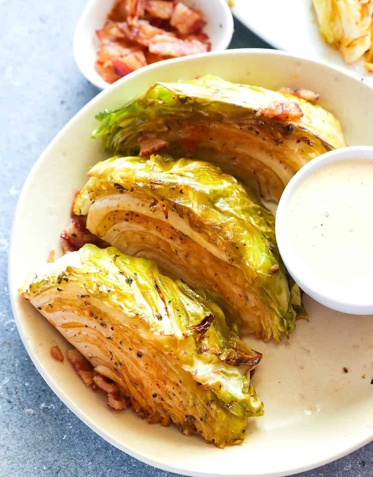 Enjoying smoked cabbage wedges with homemade remoulade sauce for an incredible side dish.