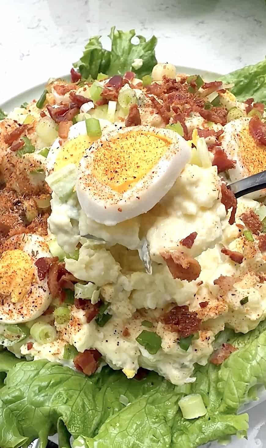 Forking into a creamy potato salad, and the perfect cookout side.
