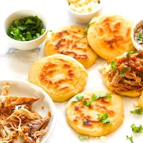 Making arepas Colombian style, thinner and topped with meat for a satisfying treat.