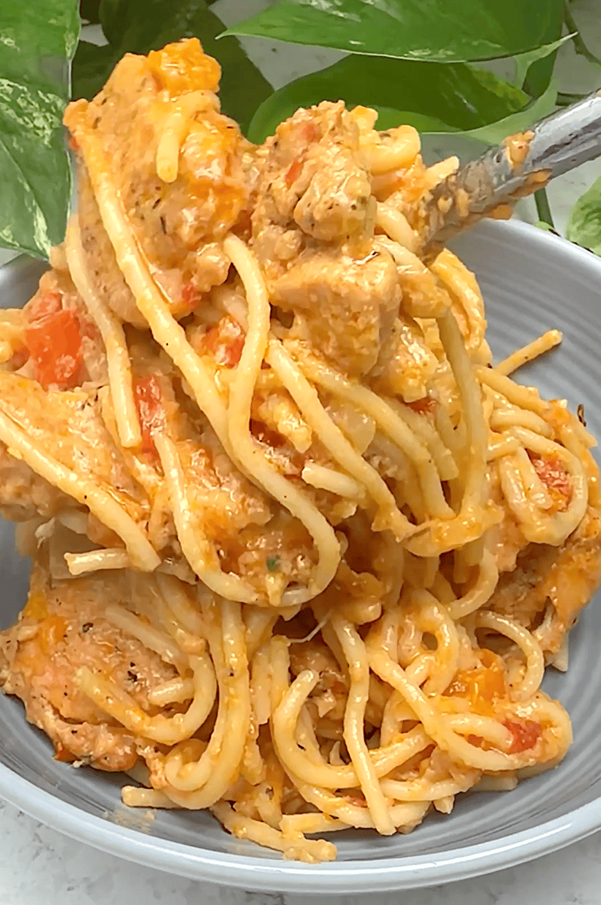 Piling easy baked spaghetti loaded with spicy chicken for a satisfying one-dish meal.