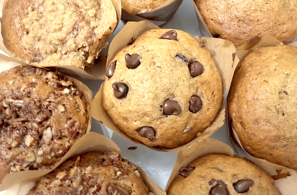 Freshly baked banana bread muffins topped with pecans, streusel, or chocolate chips. Perfect for back-to-school meal prep.