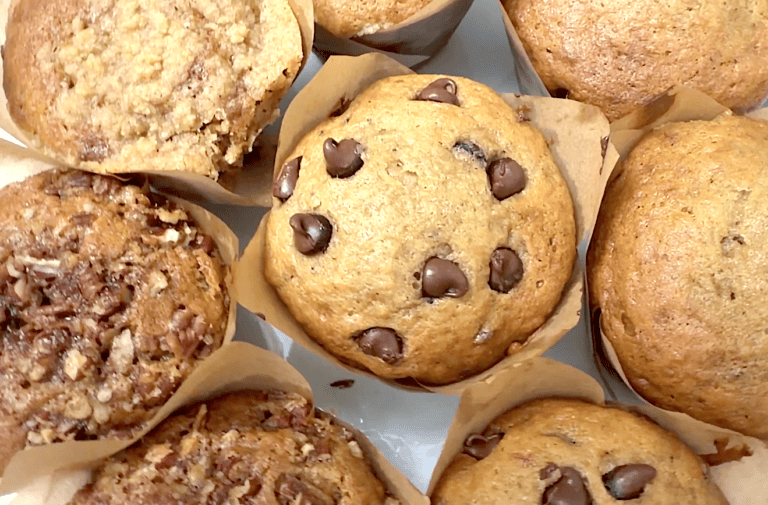 Freshly baked banana bread muffins topped with pecans, streusel, or chocolate chips. Perfect for back-to-school meal prep.