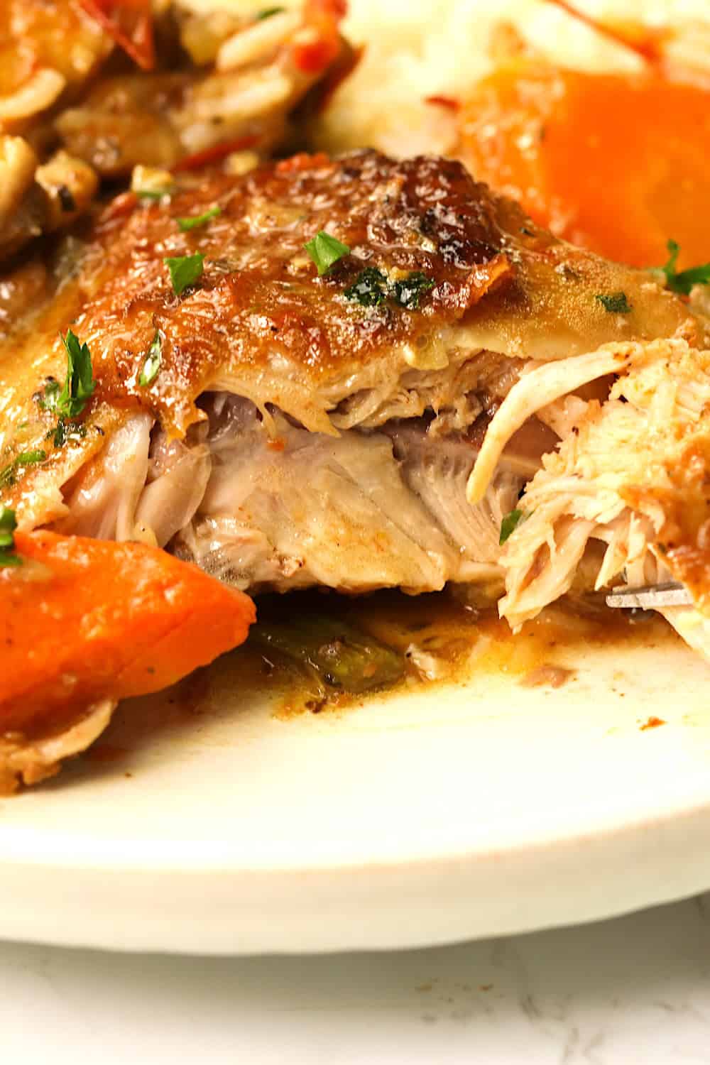 Tearing into fall-off-the-bone tender chicken thighs braised in broth and white wine for a savory and easy one-pot meal.