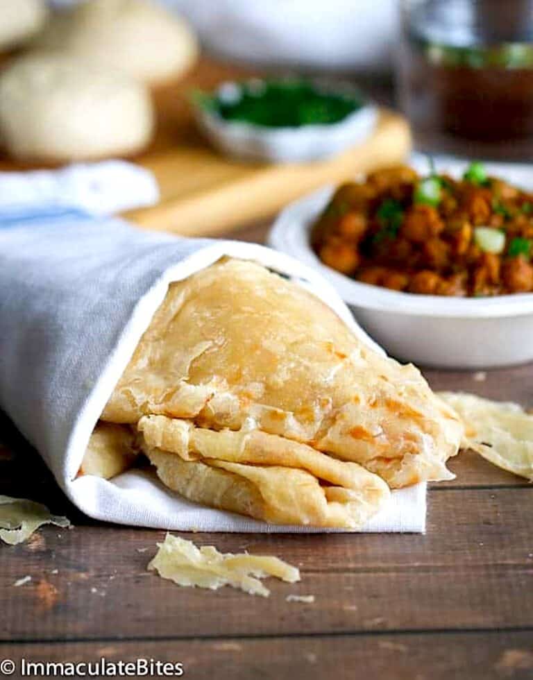 A buss up shut paratha roti wrapped in a kitchen towel to keep it warm and amazing.