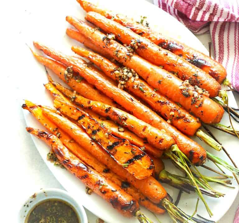 Serving herbed brown butter on the side with a platter of freshly grilled carrots.
