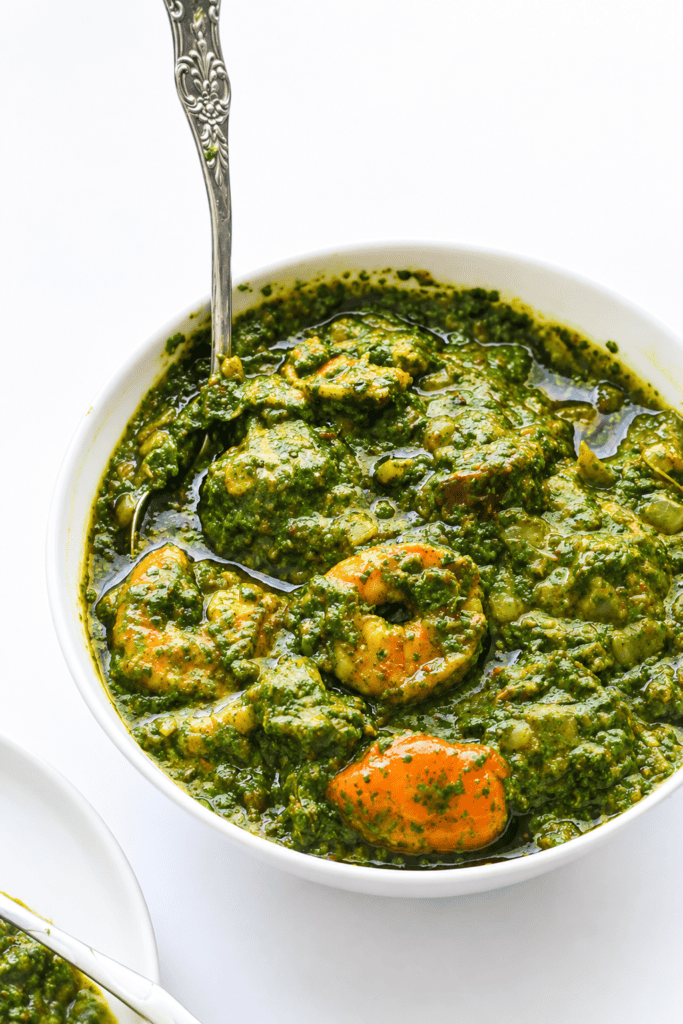 Spooning up freshly made and comforting cassava leaf soup.